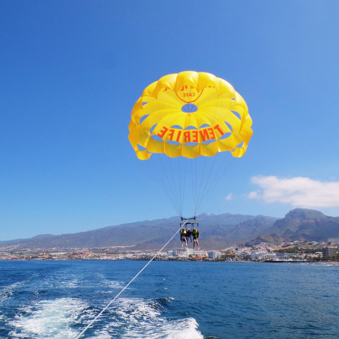 parachute flights behind a motorboat in tenerife