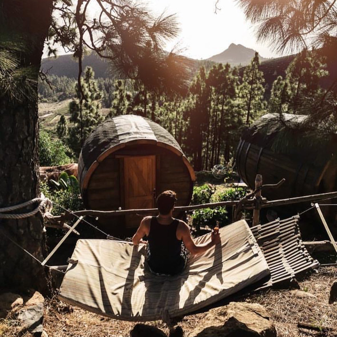 Unusual accommodation in nature - a wooden barrel among the forest with a panoramic view of the ocean